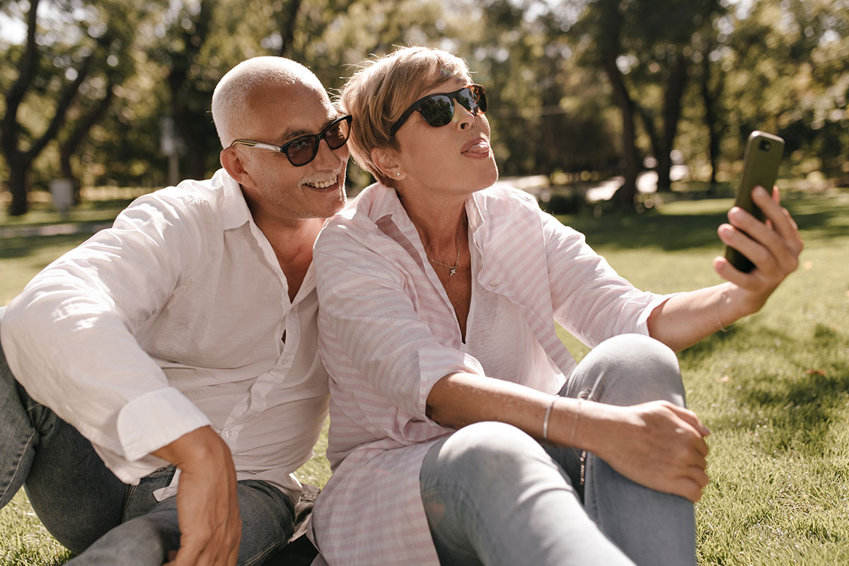 mature couple at the picnic taking selfie in glasses trt treatment concept
