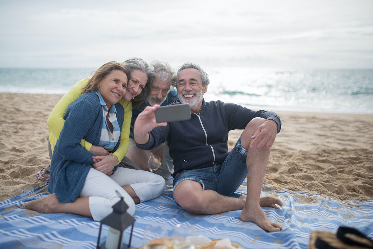 mature friends on the beach hgh for anti-aging concept