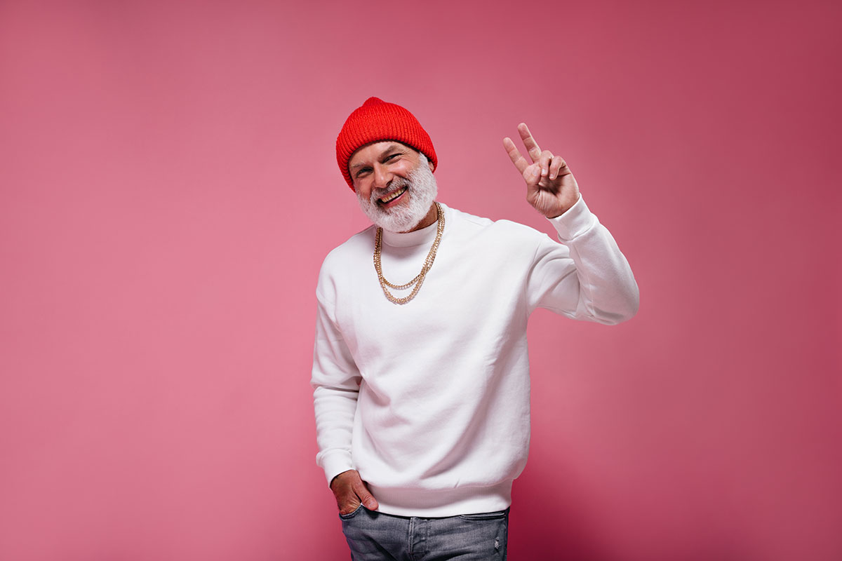 mature man smiling showing peace sign