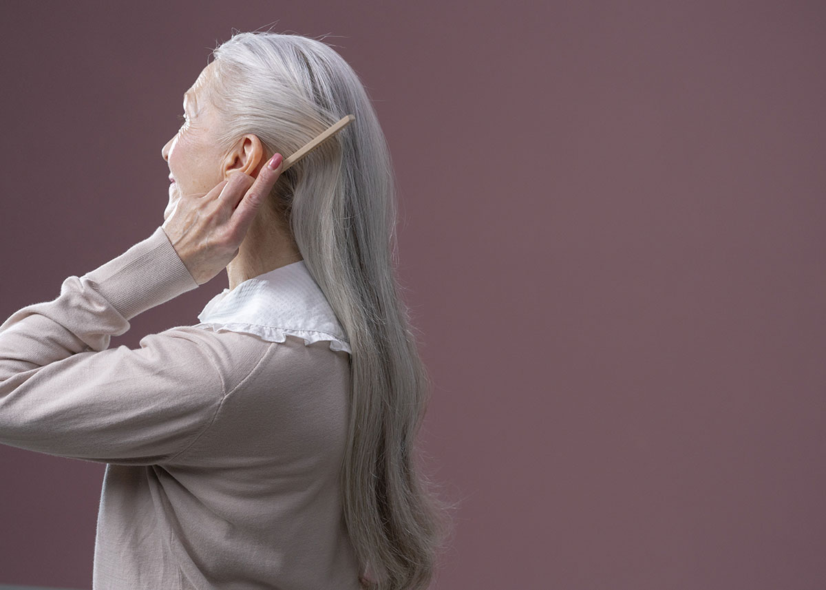 senior woman combing hair human growth hormone hair growth